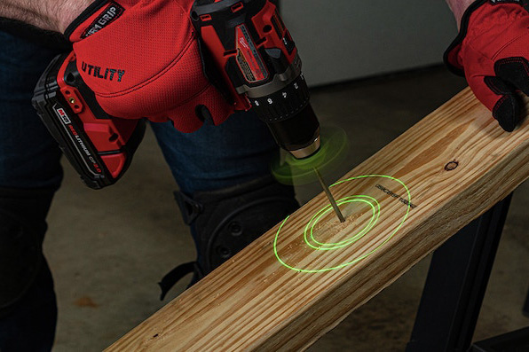 Close-up of drill with BullseyeBore Core drilling into wood, green laser circles around