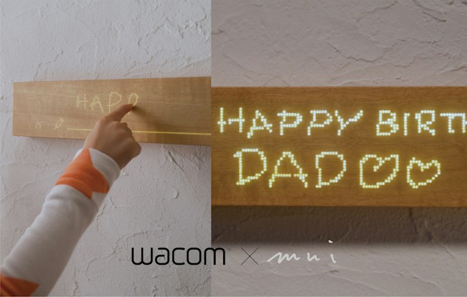 Child writing on mui Board Gen2 with light-up message saying 'HAPPY BIRTHDAY DAD.