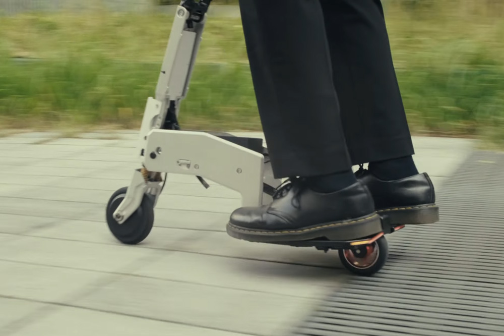 Person riding Arma Scooter on a textured path