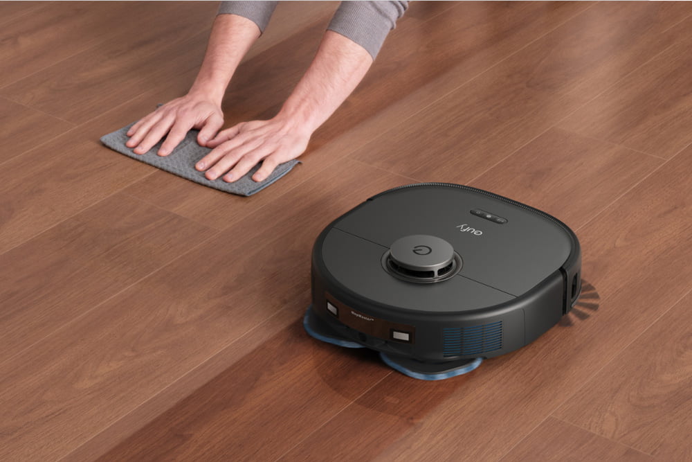 Person wiping floor as Eufy X10 Pro Omni mops