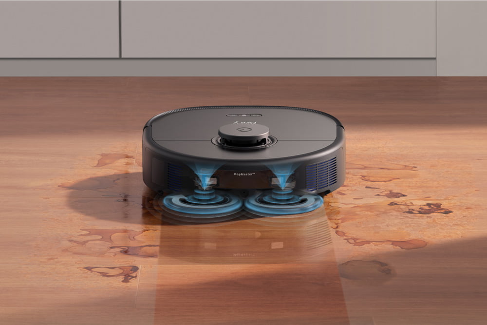 Eufy X10 Pro Omni cleaning spilled liquid on hardwood floor.