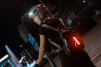 Cyclist with AURA helmet and backpack light at night