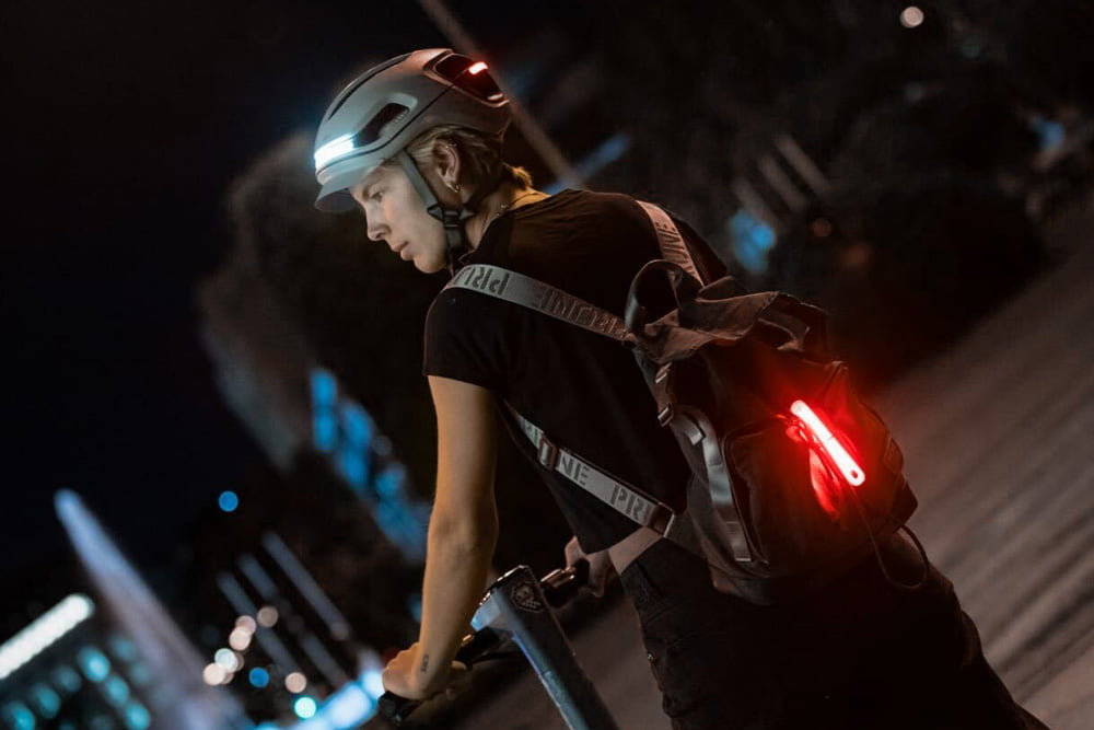 Cyclist with AURA helmet and backpack light at night