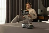 Woman reading with the Creatulize X1 on bed