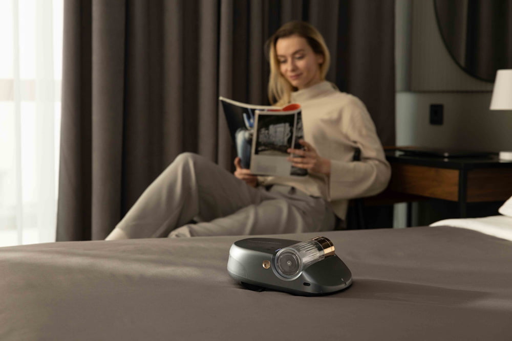 Woman reading with the Creatulize X1 on bed