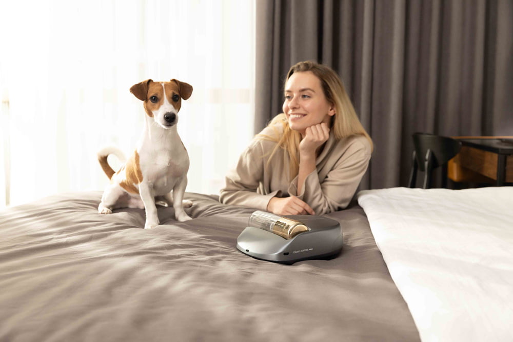 Dog sitting next to Creatulize X1 on a bed