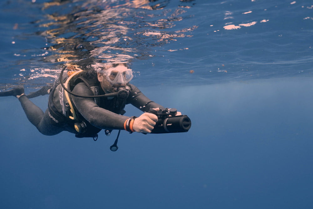 Diver photographing underwater with the LEFEET P1 scooter