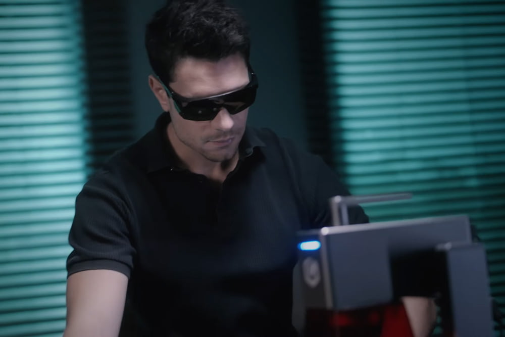 Man using the Longer Nano laser engraver with safety glasses