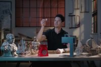 Man examining a puzzle piece made with Longer Nano