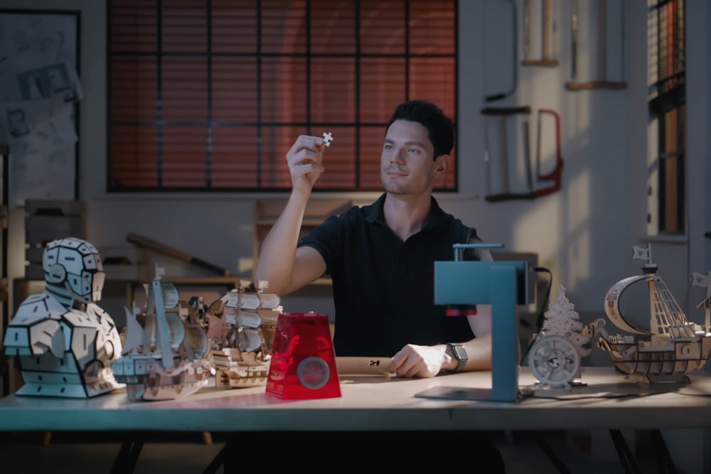 Man examining a puzzle piece made with Longer Nano