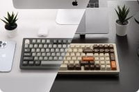 Diagonal view of Modern97 keyboard in a sleek workspace with tech and plants.