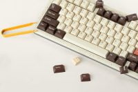 Modern97 keyboard with keycap puller and loose keys on a light surface.