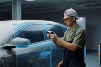 man using MIRACO 3D to scan a car