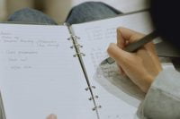 Woman writing in a smart notebook with SyncPen 4