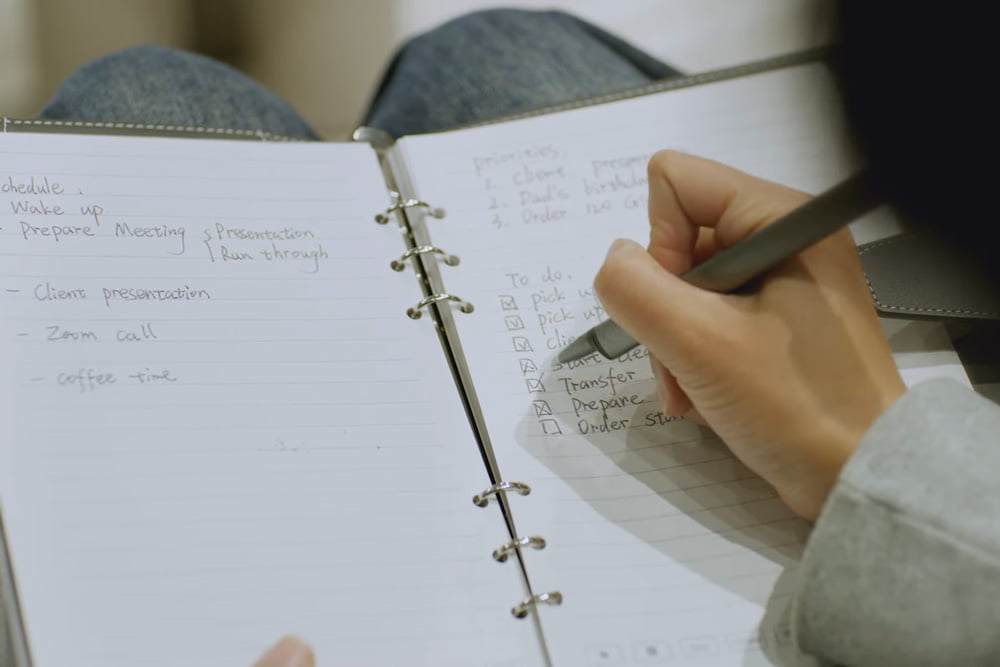 Woman writing in a smart notebook with SyncPen 4