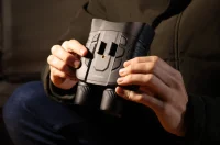 Close-up of hands changing batteries of AKASO Seemor.