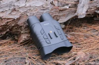 AKASO Seemor placed on forest ground among pine needles.