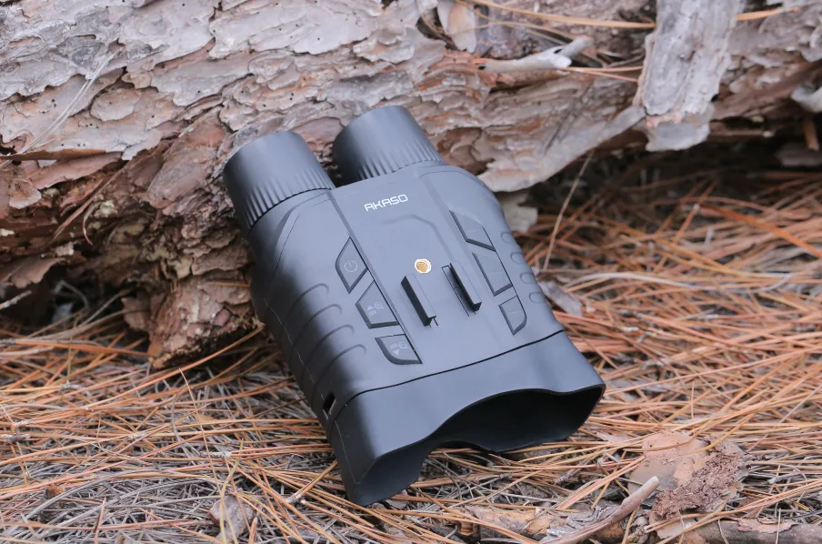 AKASO Seemor placed on forest ground among pine needles.