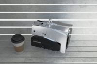 Folded Arma Scooter next to coffee cup on bench