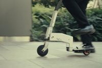Person riding Arma Scooter on pavement