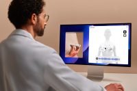 Man using BeamO with patient data on computer screen