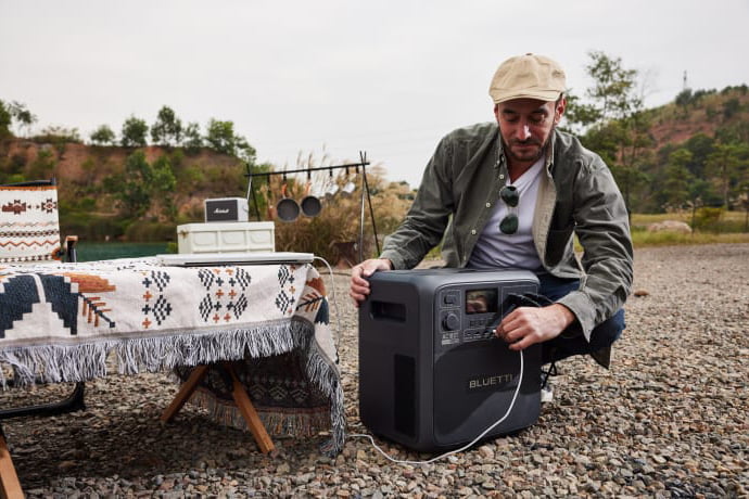 Man setting up BLUETTI SwapSolar station outdoors