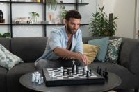 Man contemplating a move on GoChess with piece sensors