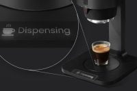 Close-up of KUKU Maker with 'Dispensing' illuminated on its base.