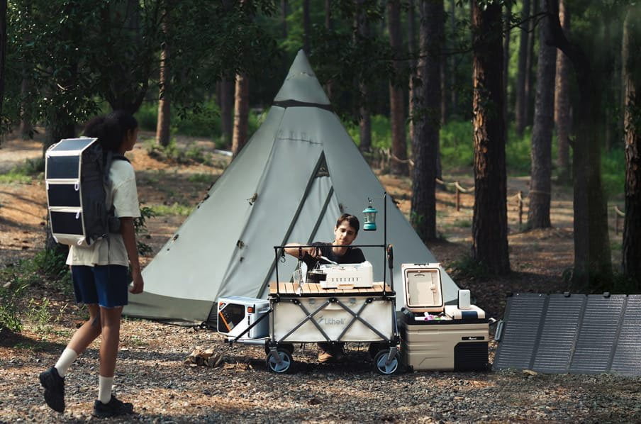Two people camping in a forest and using Litheli W1 Pro