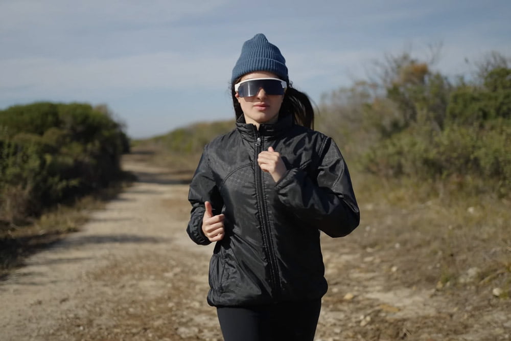 Runner wearing Minimis Glass on a dirt trail