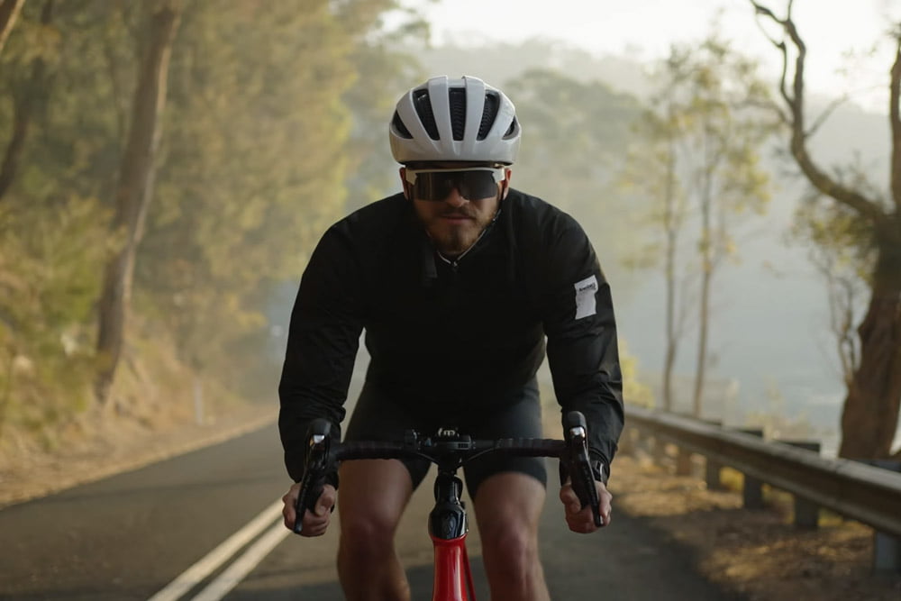 Cyclist in a black outfit wearing Minimis Glass