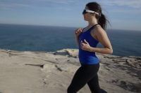 Female runner wearing Minimis Glass by the sea