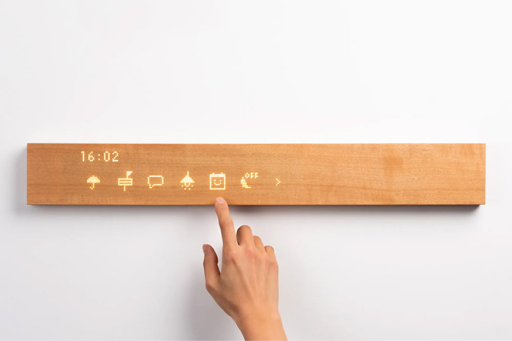 Close-up of a hand using the mui Board Gen2 to control smart home features.