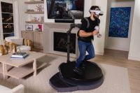 Individual actively using Omni One VR treadmill in a living room