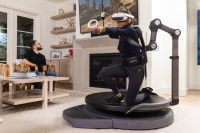 Gamer using Omni One treadmill with motion arm for VR experience
