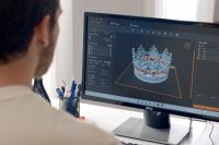 Person using software to prepare a 3D model for printing on Phrozen Arco