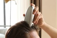 man using Rootique on his head