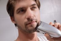 man using Rootique on his beard
