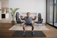 Man squatting with smart fitness technology by Tempo Studio