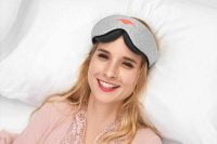 woman wearing Manta Sleep Mask on bed