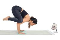 YogiFi user following yoga pose instructions from a tablet