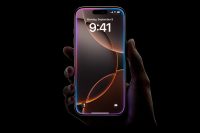 Hand holding the iPhone 16 Pro with a glowing lock screen displaying the time "9:41" and date.